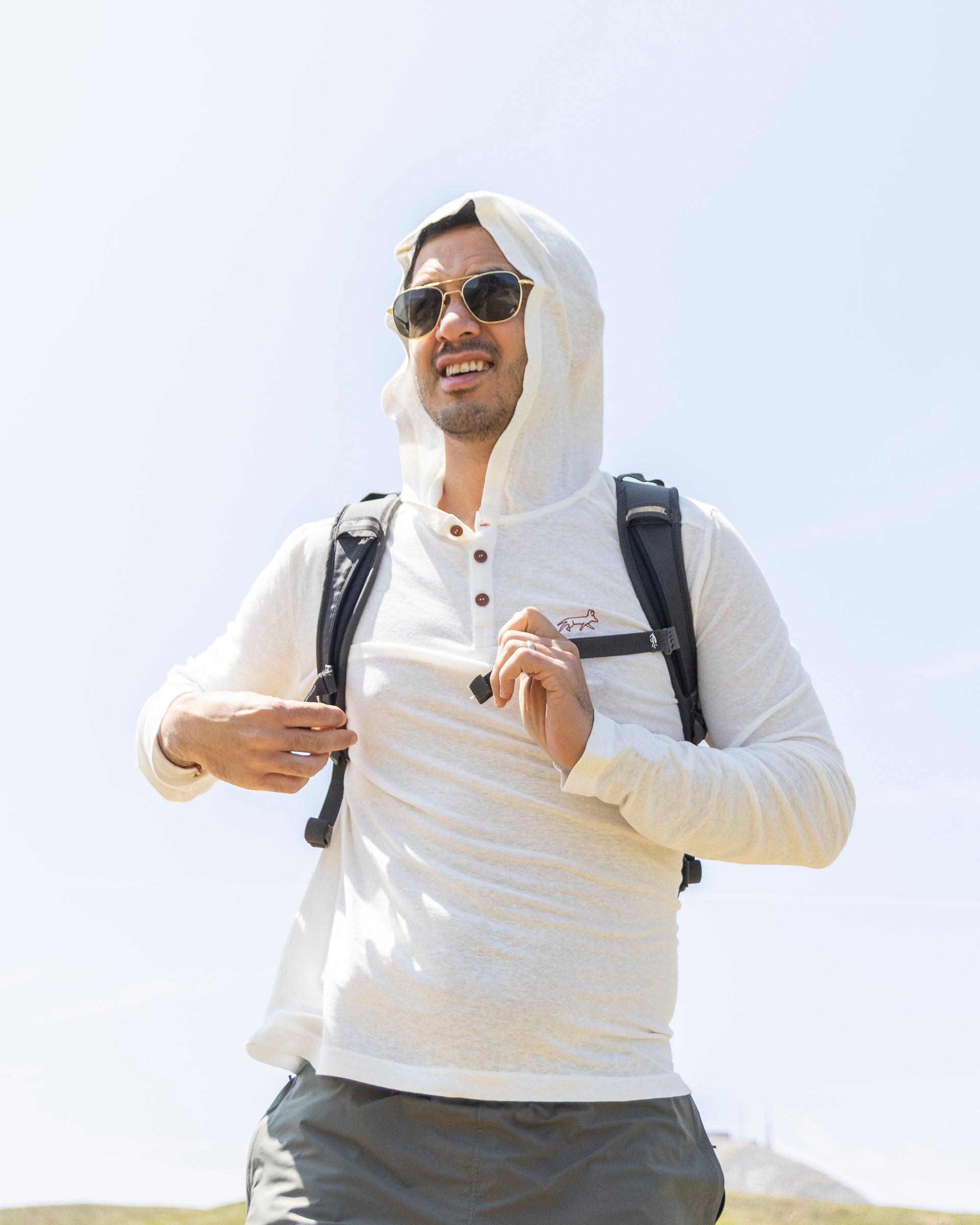 White Sands - Men's Sun Henley with Hideaway Hood worn with the hood up, studio view
