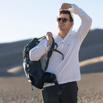 White Sands - Men's Sun Henley with Hideaway Hood in white, worn on desert dunes