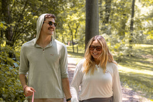 White Sands - Women's Long-Sleeve Hooded Henley in Desert Willow (White) and White Sands - Men’s Long-Sleeve Hooded Henley in Agave (Light Green)