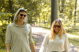 White Sands - Women's Long-Sleeve Hooded Henley in Desert Willow (White) and White Sands - Men’s Long-Sleeve Hooded Henley in Agave (Light Green)