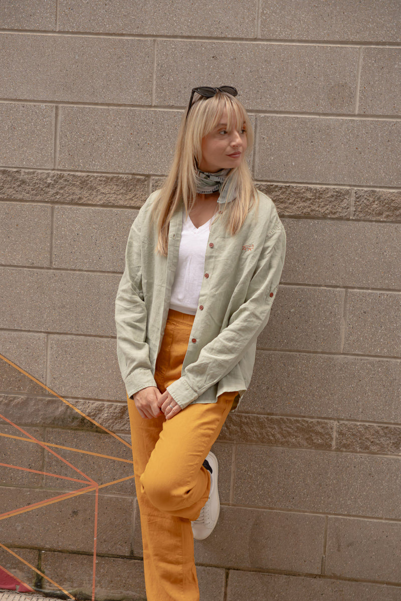 Woman wearing Joshua Tree - Women's Breathable Hemp Trail Pants in Orpiment (Turmeric) and Canyonlands - Women’s Long-Sleeve Ventilated Hemp Shirt in Agave (Light Green)
