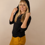 White Sands - Women's Long-Sleeve Hooded Henley in Obsidian (Black) (Front view with hood on)