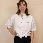 Everglades - Women's Ventilated Short Sleeve Hemp Shirt in white, knotted at the waist, studio view