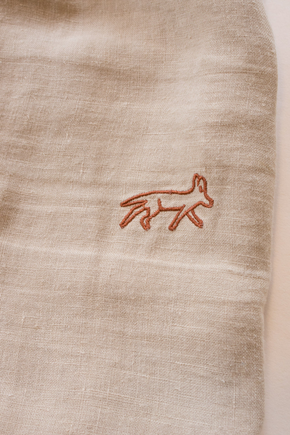 Textured beige fabric with terlingua threads logo
