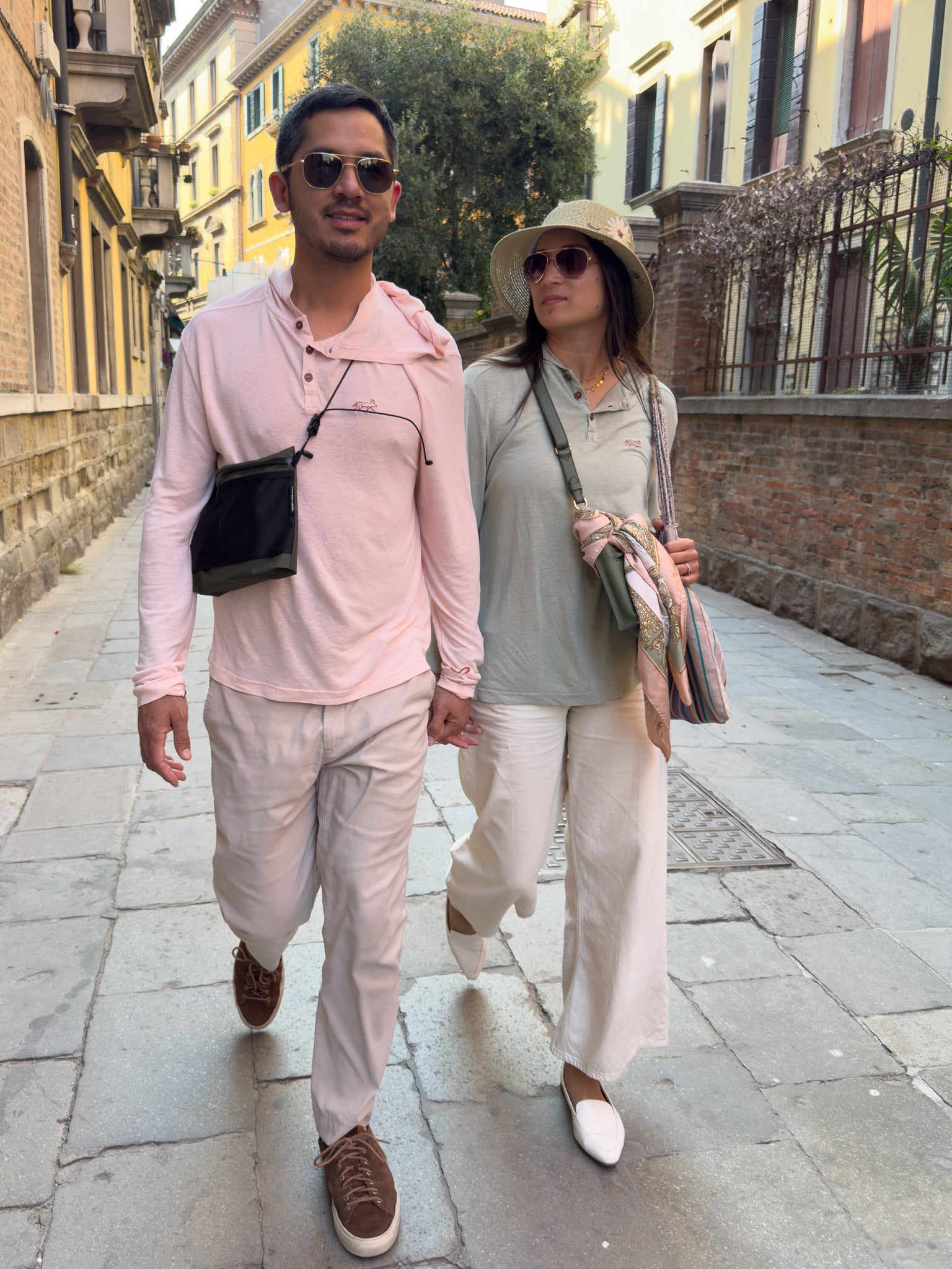 Two people walking down a street in an urban setting